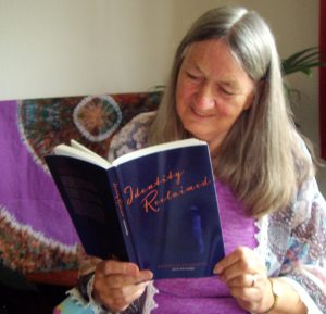 Photo of bestselling author Sheila Jeffries, reading her copy, in Somerset.