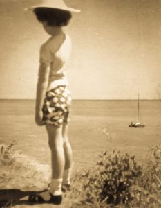 Sepia photo of Julie aged 8, overlooking the English Channel. The same image of the child that appears, isolated, on the cover of the book, 'Identity Reclaimed: Echoes of an Adoptee'.